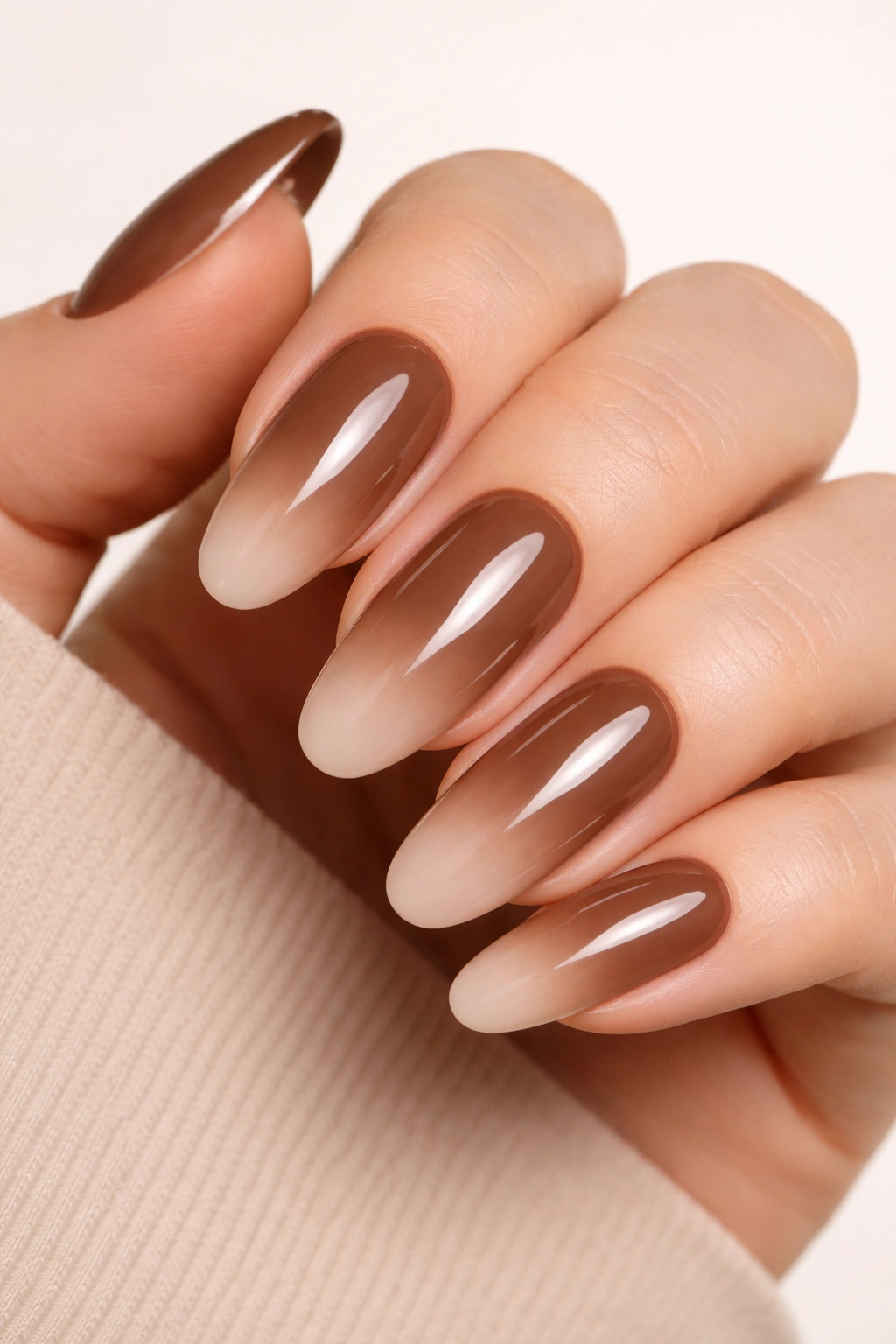 Mocha nails with soft nude ombre tips on long oval nails