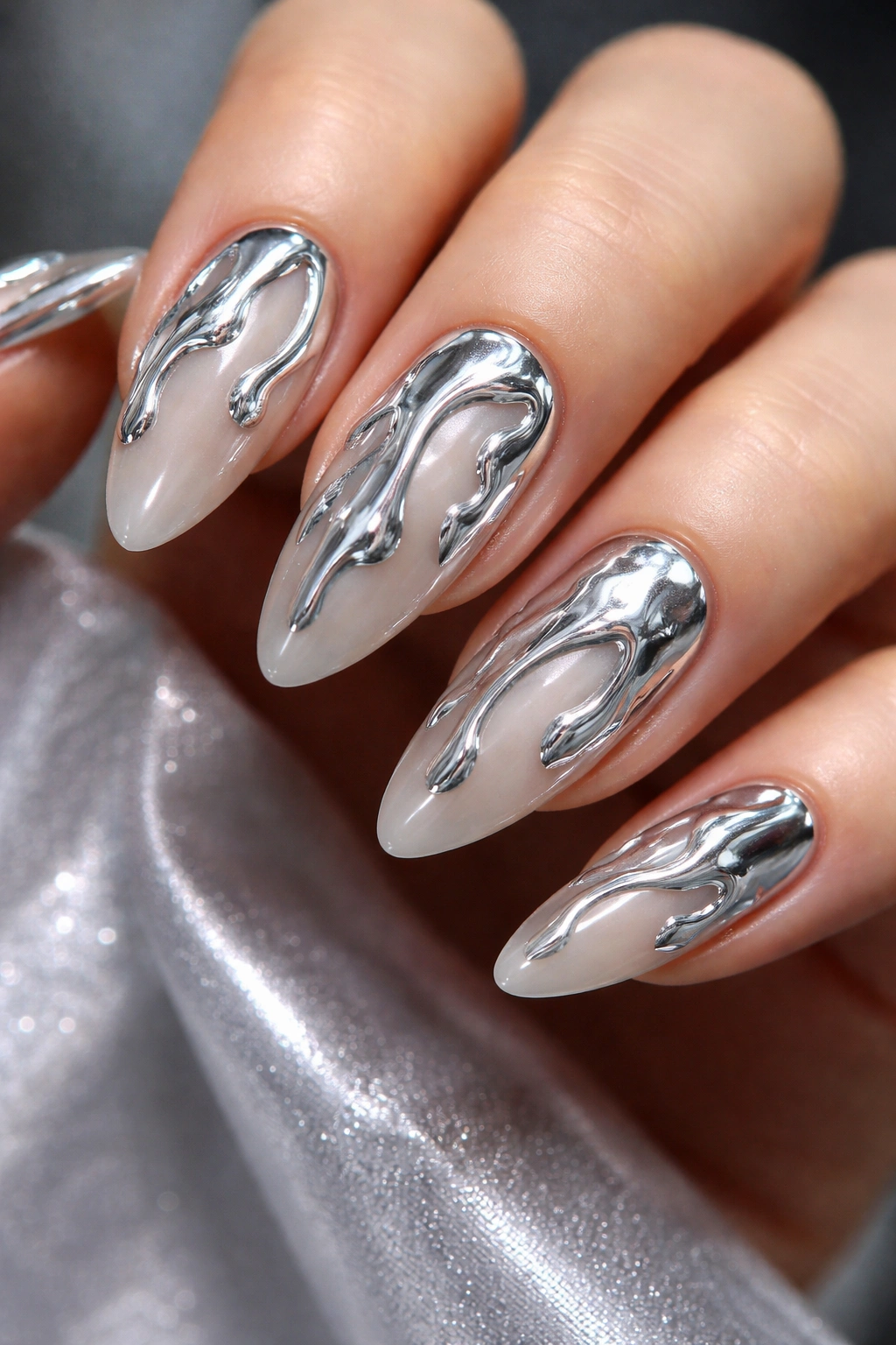 Almond nail with raised chrome drip on matte base, macro