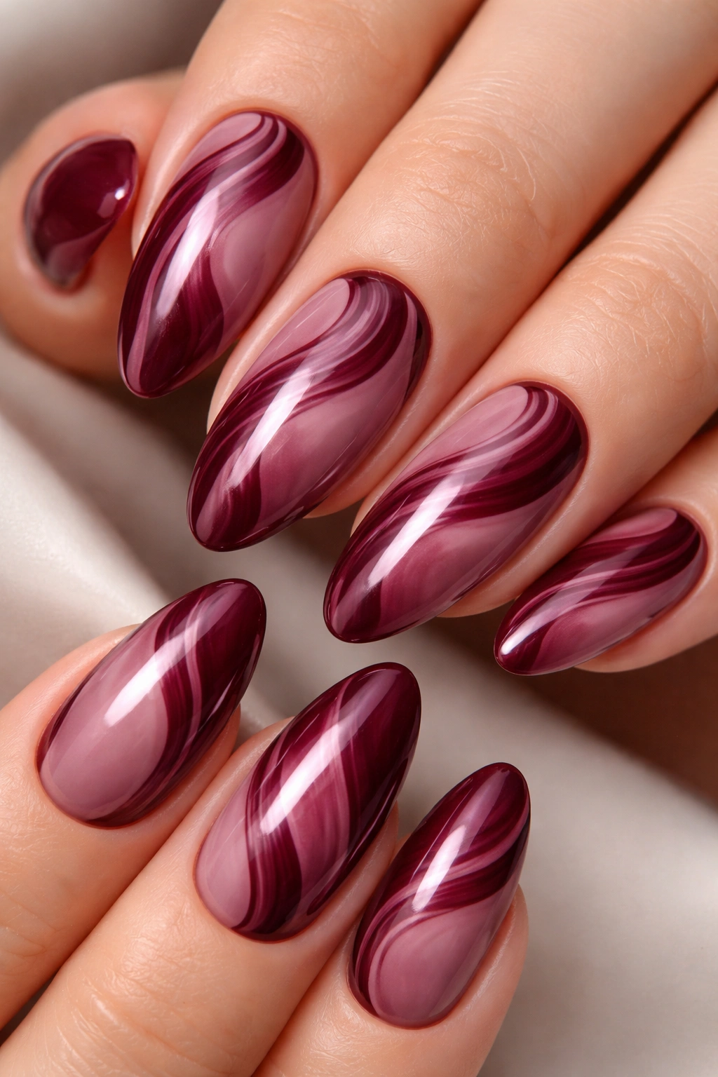 Monochromatic burgundy swirl nails on mauve base