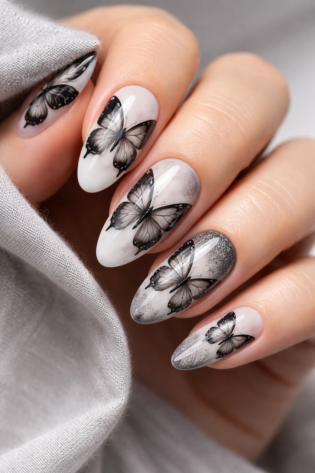 Close-up of black and white monochrome butterfly nail art in grayscale