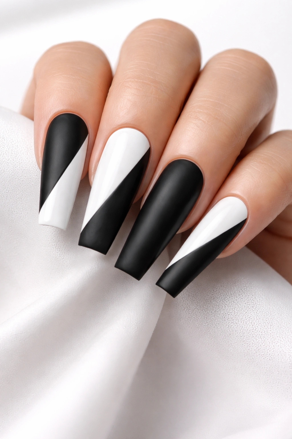 Coffin nails showing gloss white and matte black texture contrast