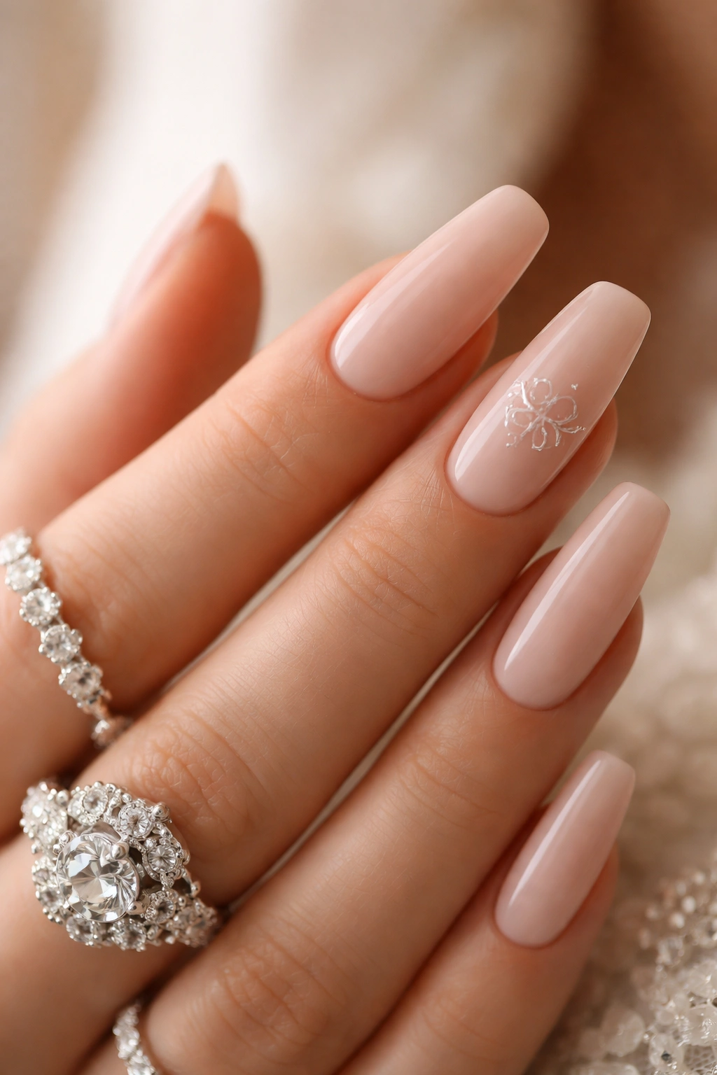 Nail with subtle monogram-inspired decorative motif on an heirloom-style nail