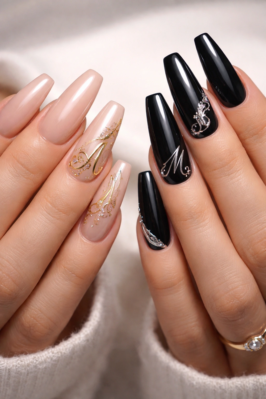 Long nails with monogram-inspired embellishments on accent nails