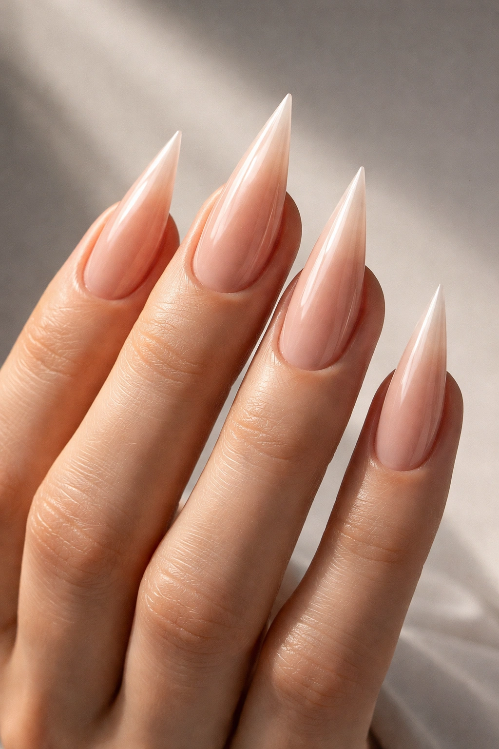 Close-up of a hand with mountain peak nails featuring a central sharp peak