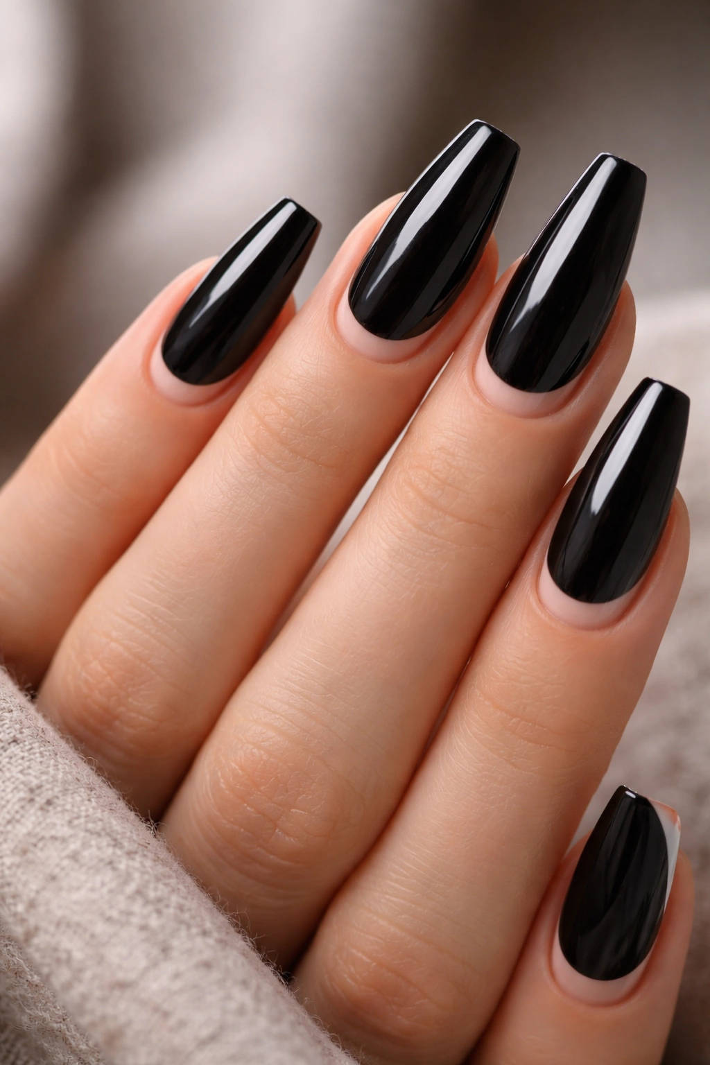 Close-up of coffin nails with glossy black and nude tips