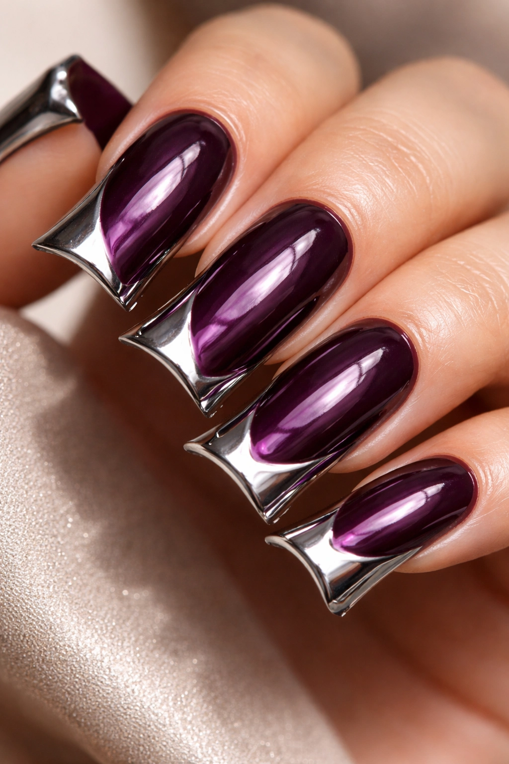 Deep plum curved nails with chrome edge accents