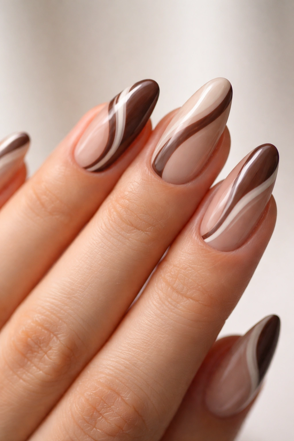 Close-up of short almond nails with diagonal two-tone wavy lines