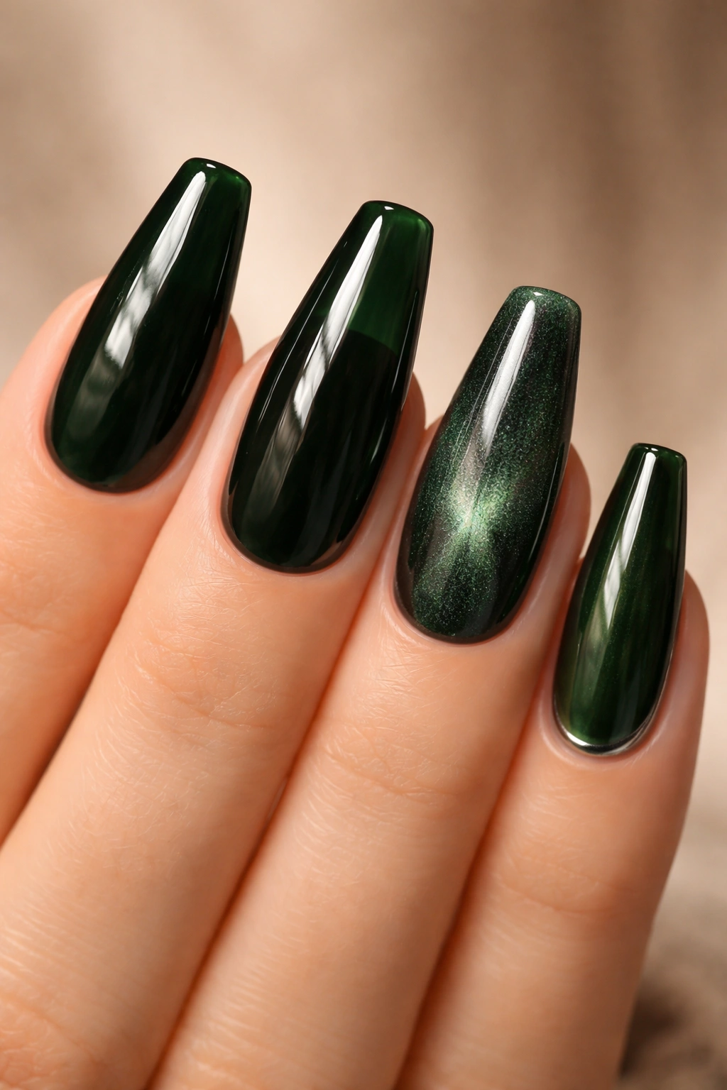 Nails displaying glossy, jelly, velvet, and chrome finishes on dark green polish