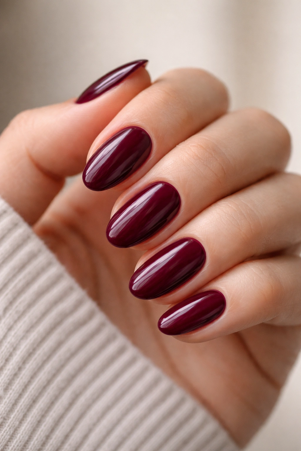 Close-up of well-prepped burgundy nails with clean cuticles and smooth surface