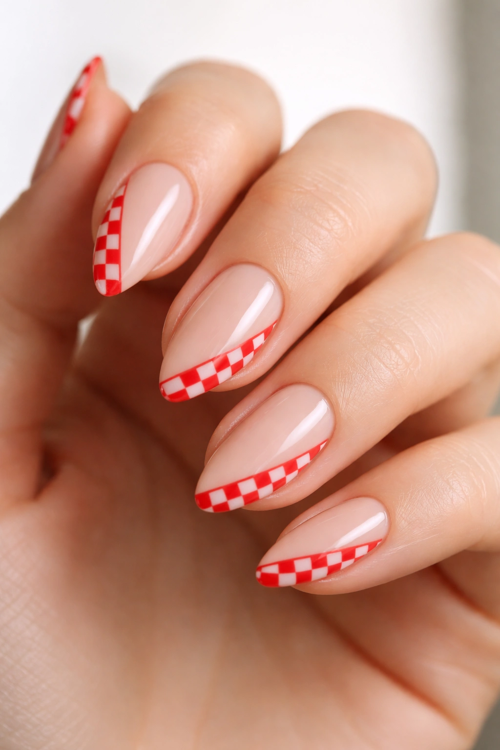 Close-up of short almond nails showing elongation tricks and angled lines