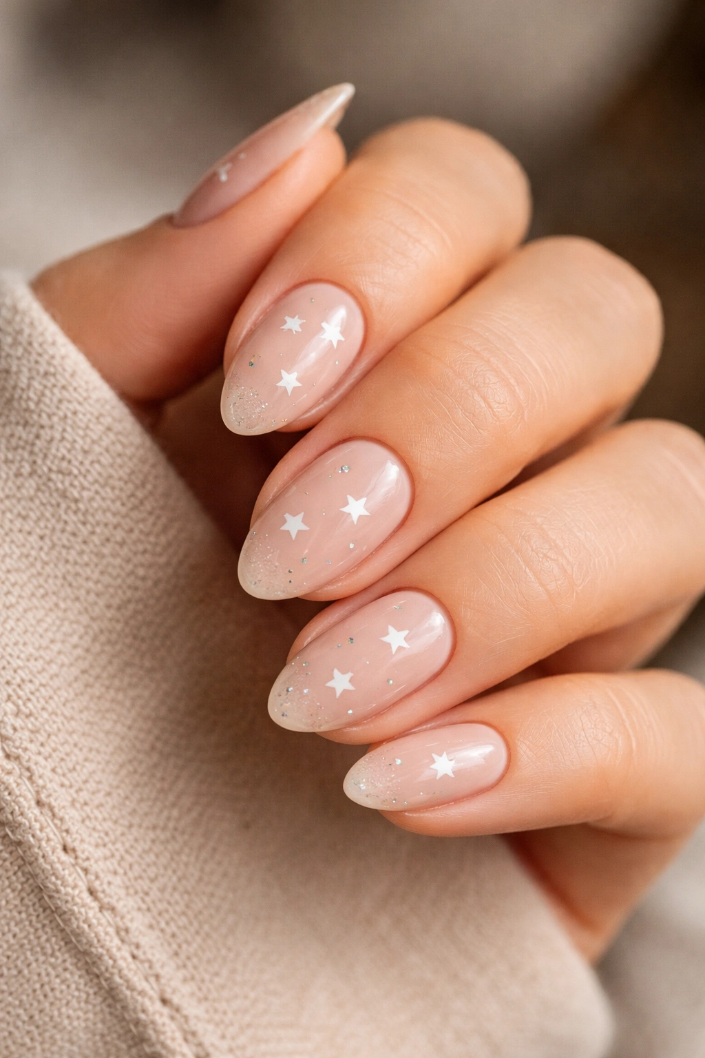 Close-up of short almond nails showing shape and length impact on star design