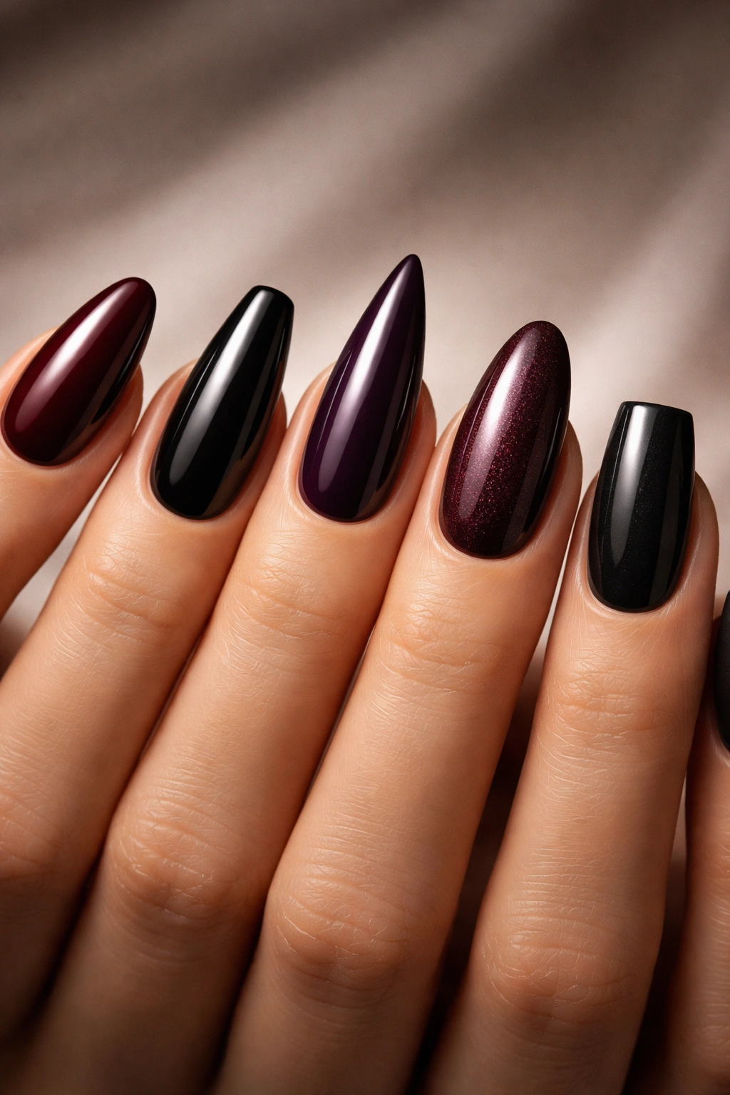 Nails in multiple moody shapes showing almond, coffin, stiletto, oval and square styles