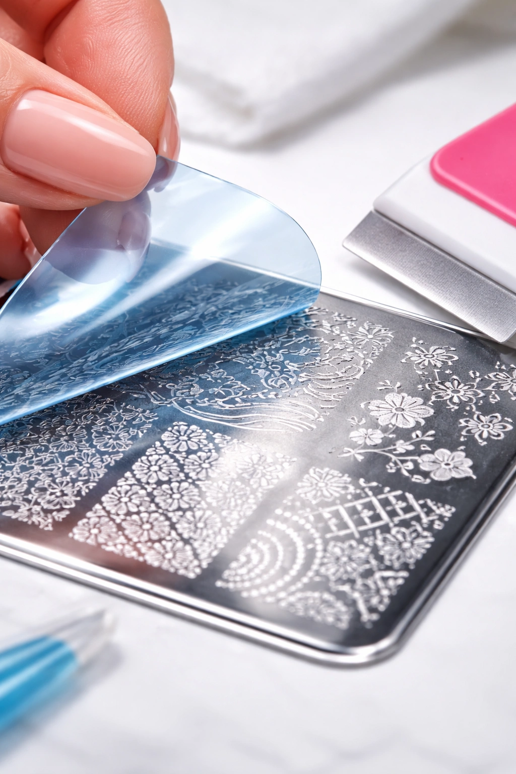Macro close-up showing protective plastic on stamping plate being peeled, illustrating beginner mistakes