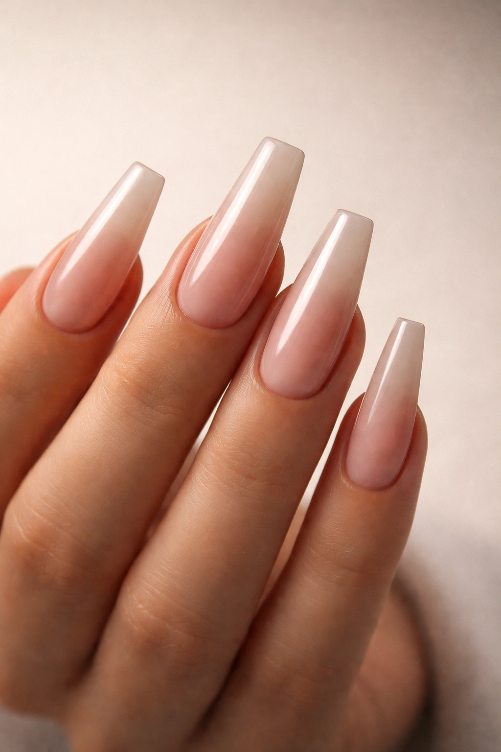 Close-up of impeccably shaped coffin nails on a hand.