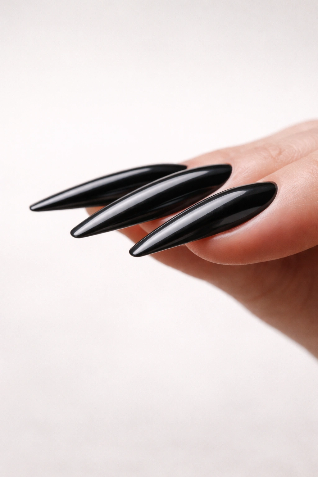 Side profile of long ballerina nails showing apex placement and slim free edge