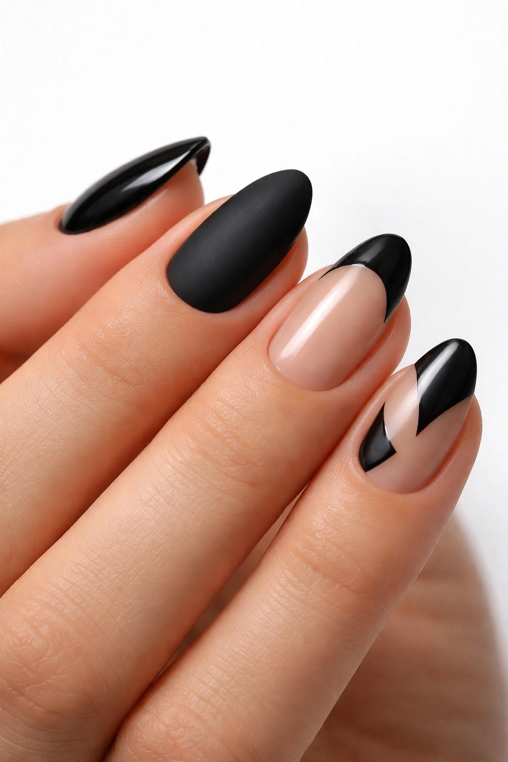 Close-up of a hand with four short almond nails showing different finishes