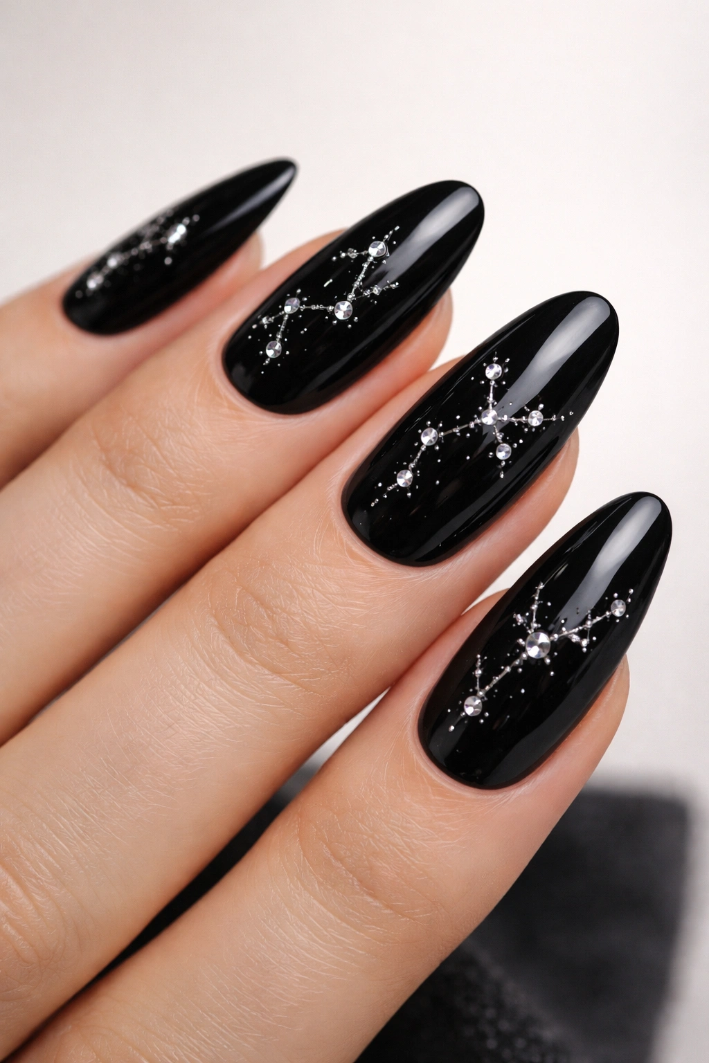 Black gloss nails with silver rhinestone constellation clusters