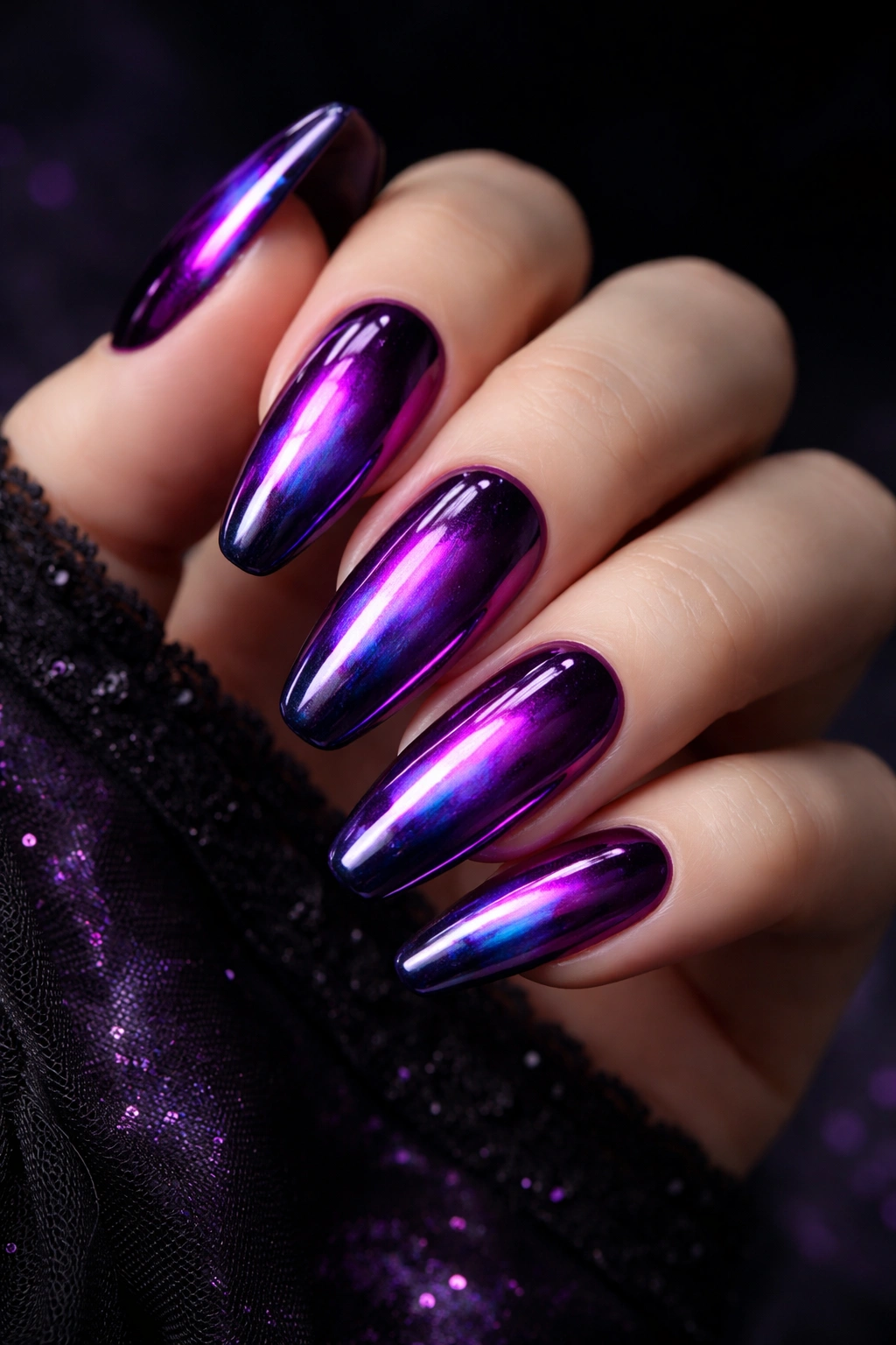 Close-up of witchy purple chrome nails with iridescent finish
