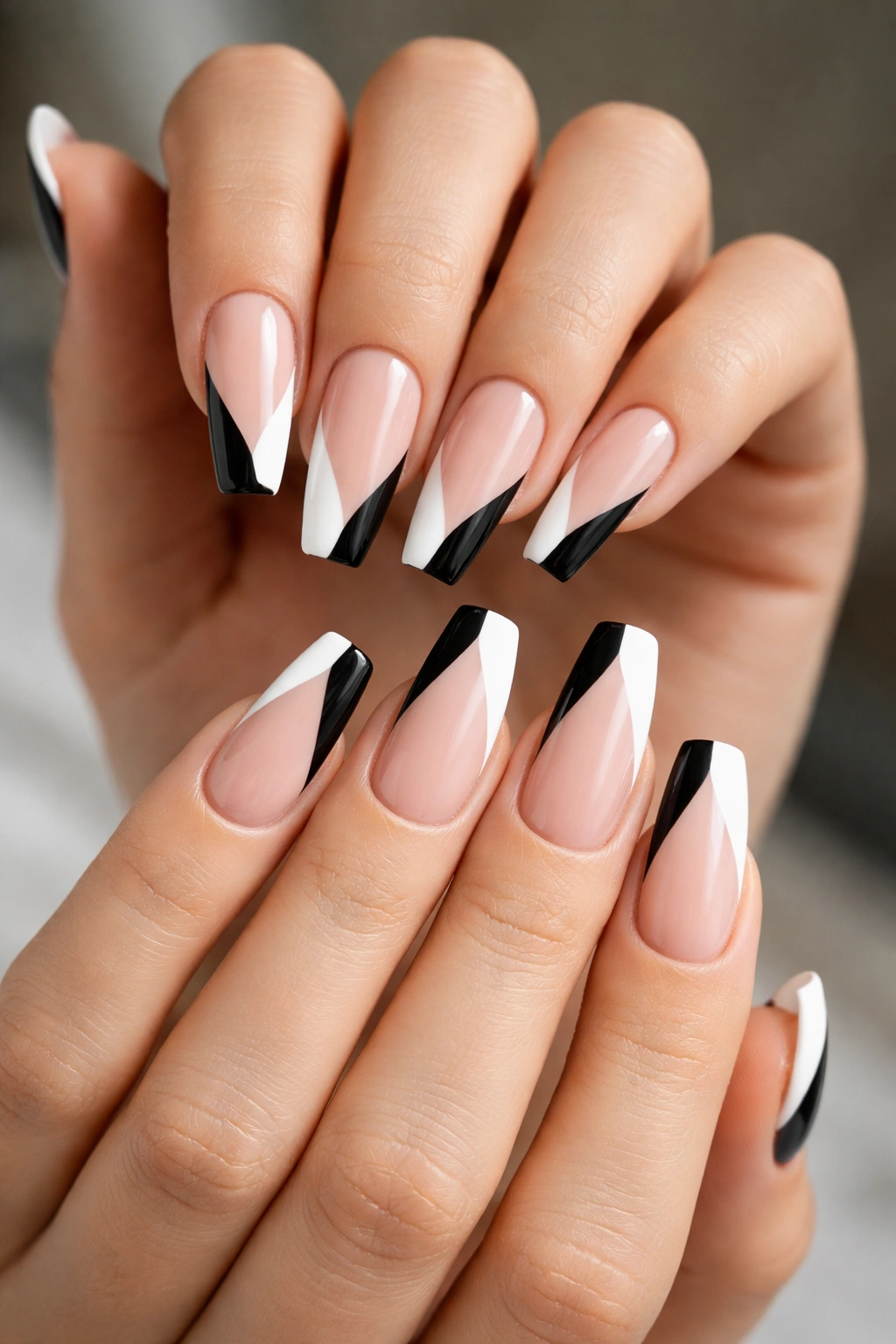 Close-up of diagonal color-block nails mirrored across both hands
