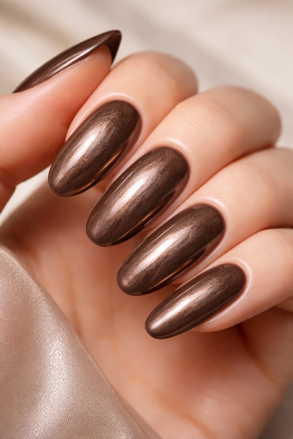 Chocolate brown nails with pearl shimmer finish on long round nails