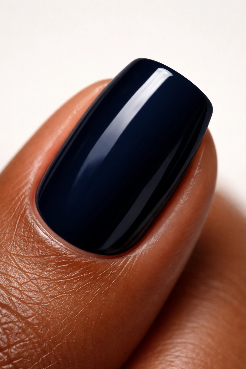 Close-up of a fingernail painted navy blue