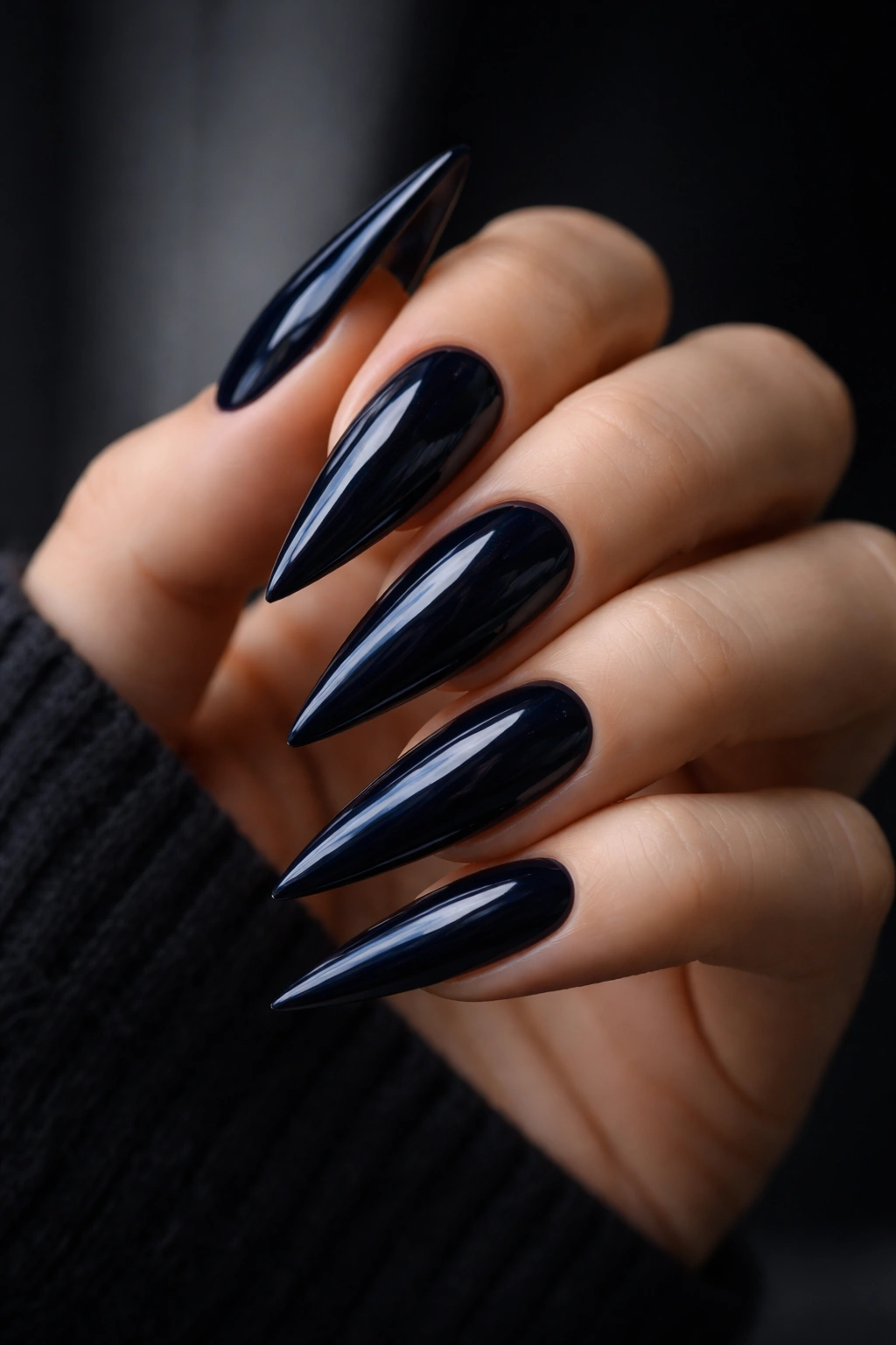 Close-up of midnight navy blue stiletto nails with high shine