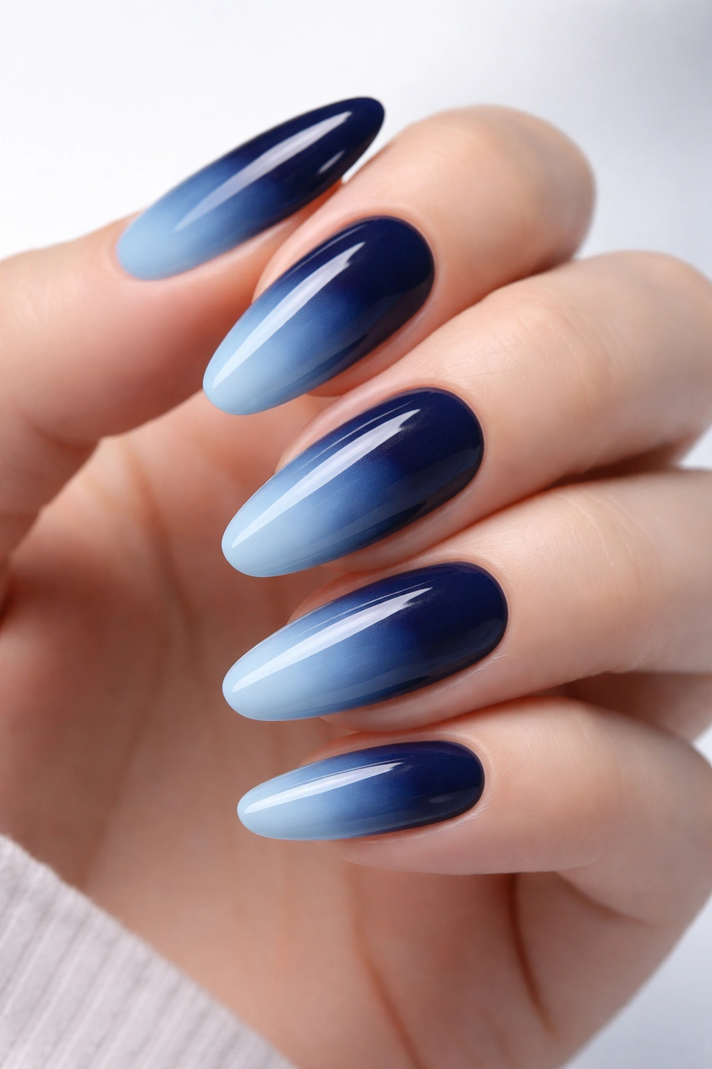 Close-up of ombre navy to light blue nails with gradient