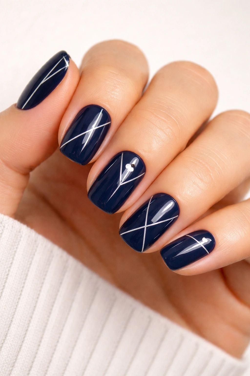 Navy nails with white geometric line art