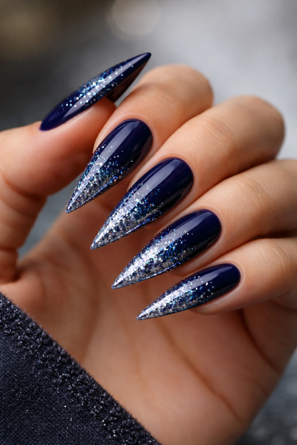 Navy stiletto nails with glitter gradient from base to tip