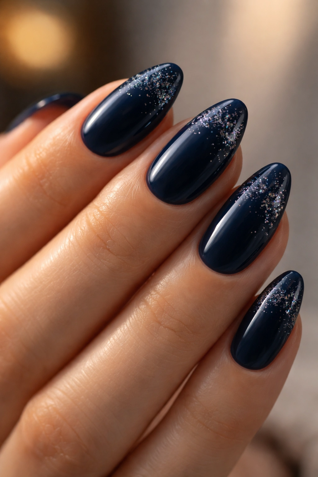 Navy almond nails with subtle glitter fade at tips