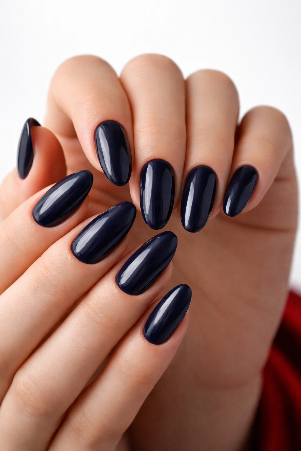 Close-up of navy blue nails with glossy finish on fingers