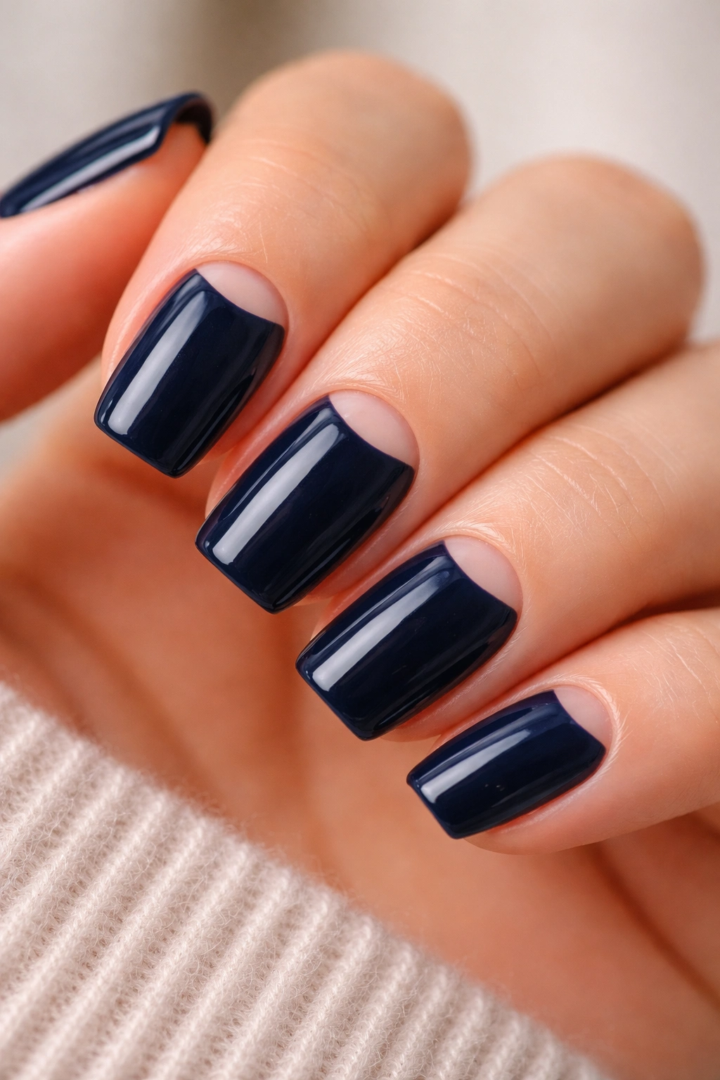 Short navy nails with a slim half-moon near the cuticle