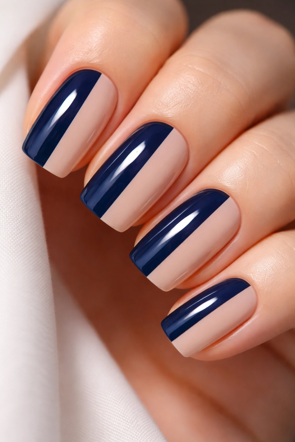 Navy and nude split-tone nails on squoval nails