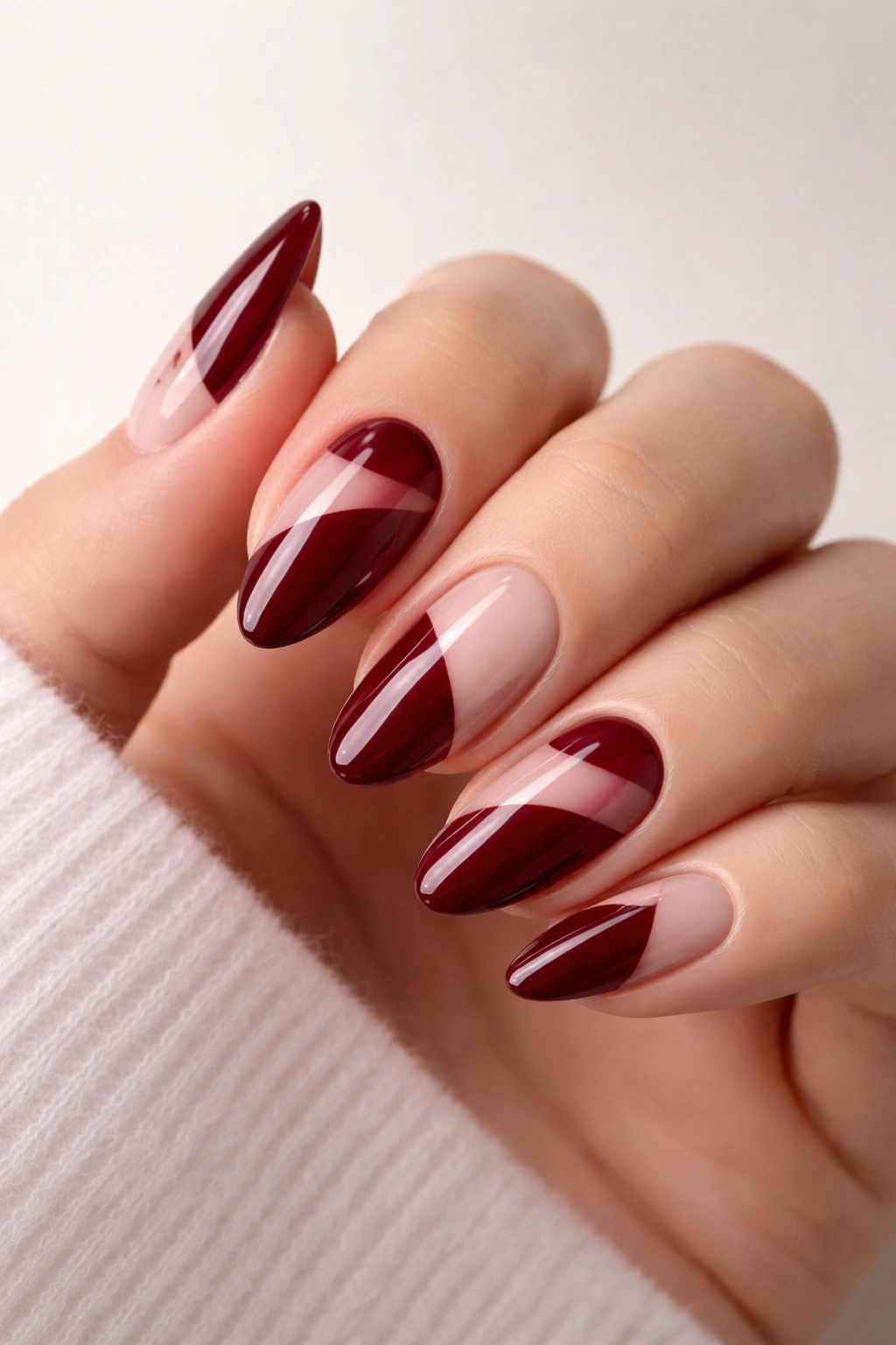 Negative space burgundy nails with geometric clear sections