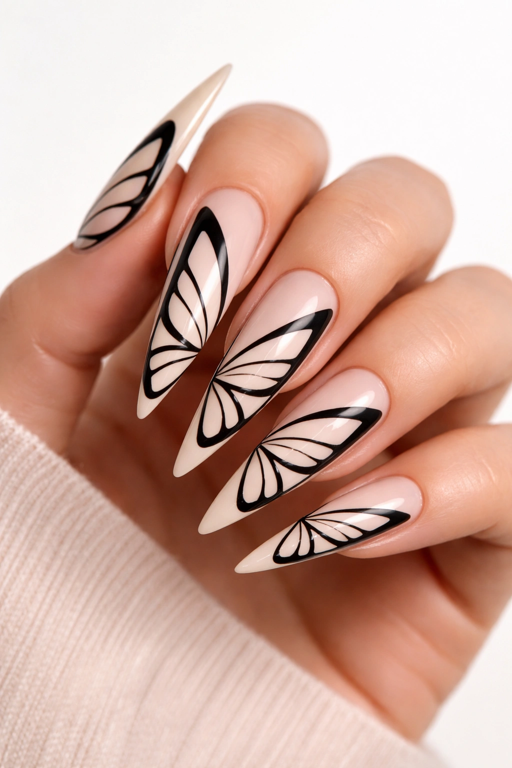 Negative space butterfly nail art in black on nude base