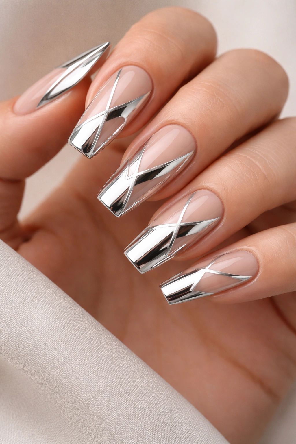 Close-up of coffin nails showing negative-space geometric chrome patterns