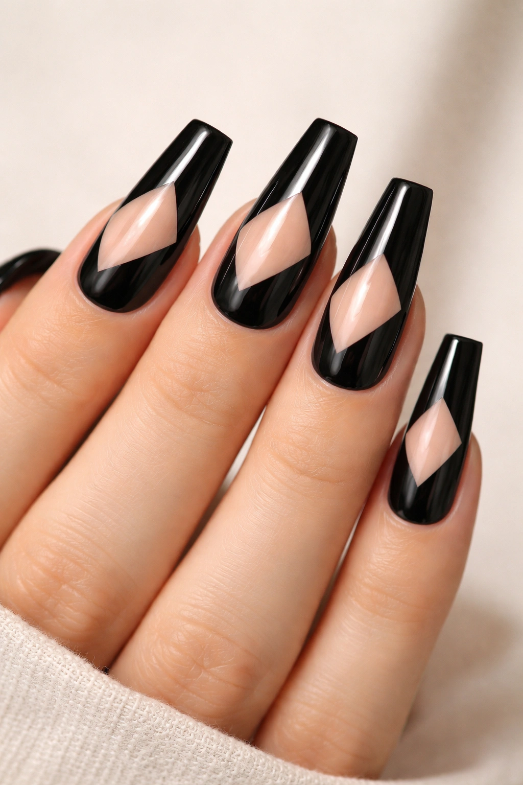 Close-up of negative-space black coffin nails with geometric cutouts