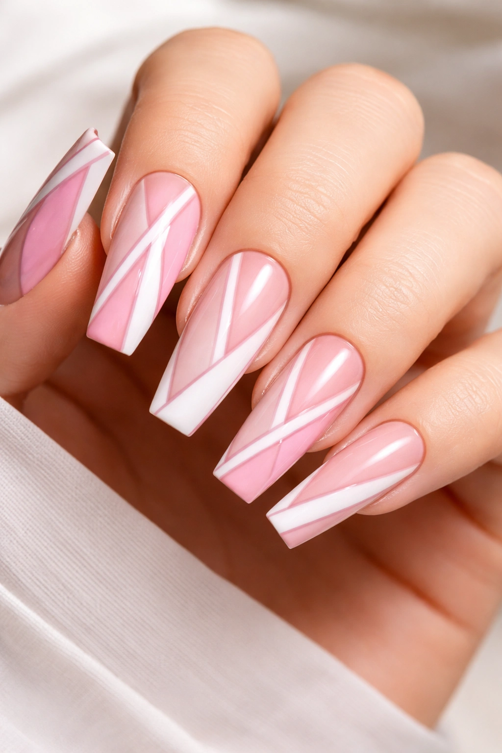 Close-up of long coffin nails with negative-space geometric design