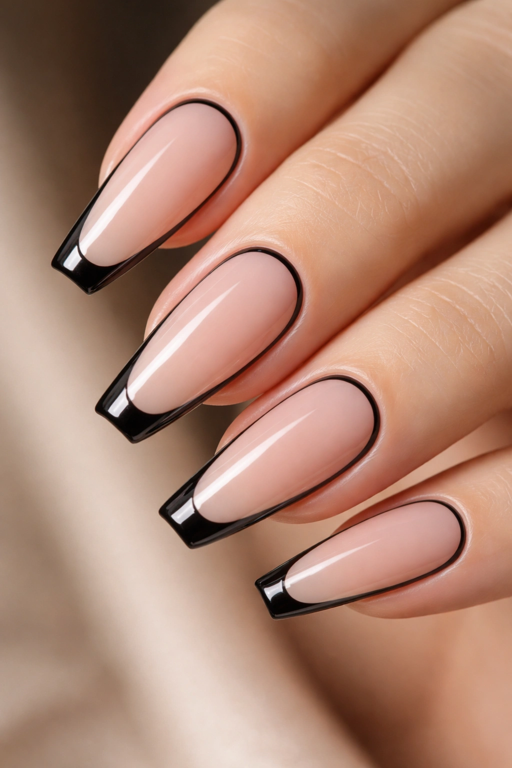 Negative-space black frame tips on ballerina nails
