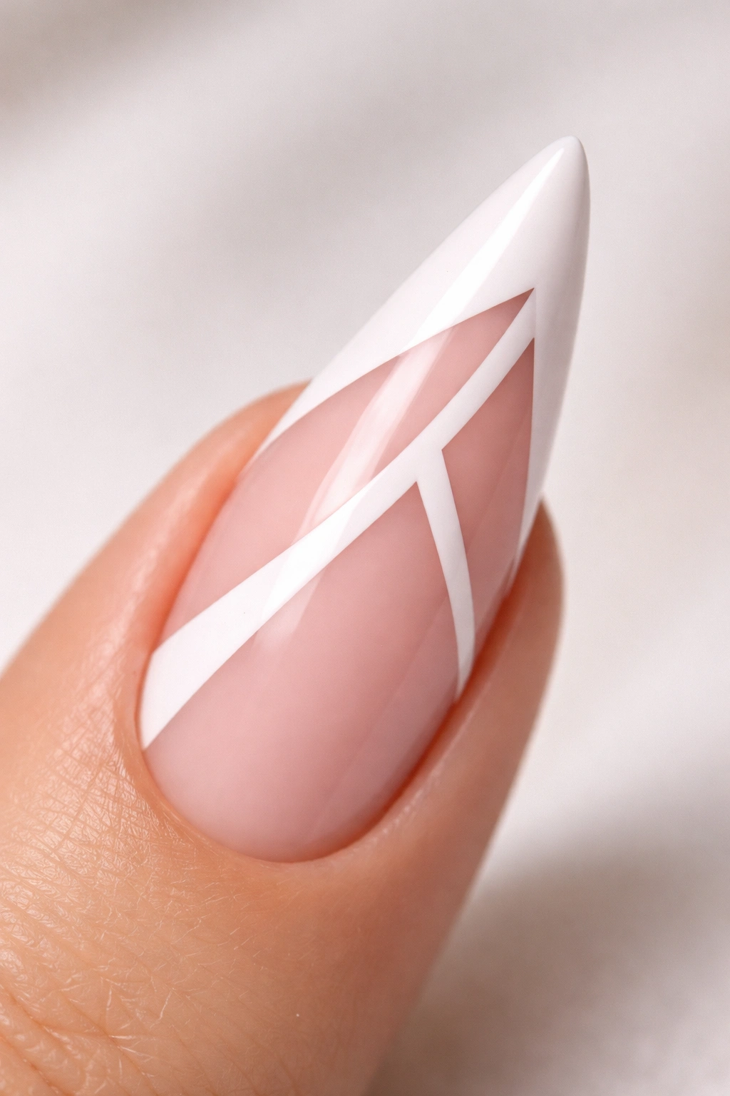 Stiletto nail with negative-space geometric gaps in the white tip