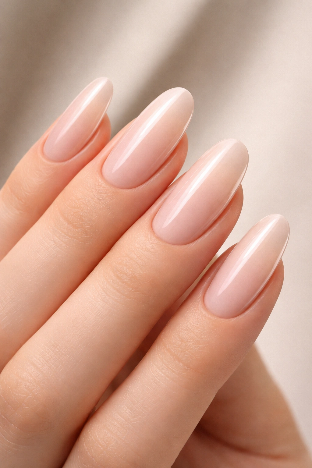 Close-up of nails with pale pink base and negative space on sides