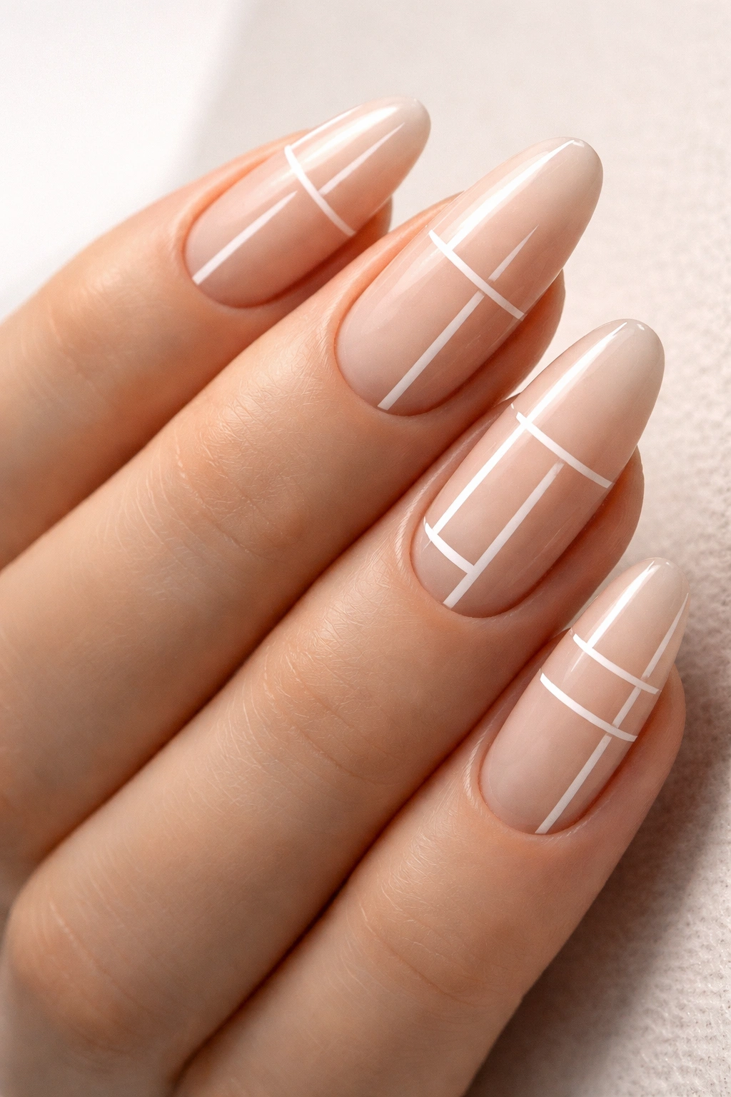 Long oval nails with minimalist negative-space geometric patterns