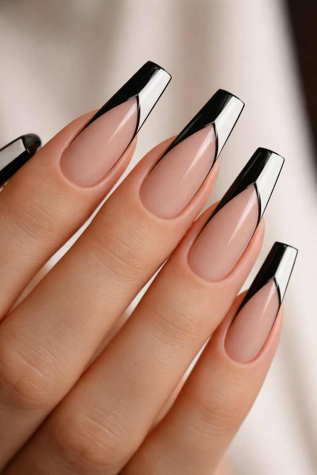 Close-up of coffin nails with negative-space geometric design.
