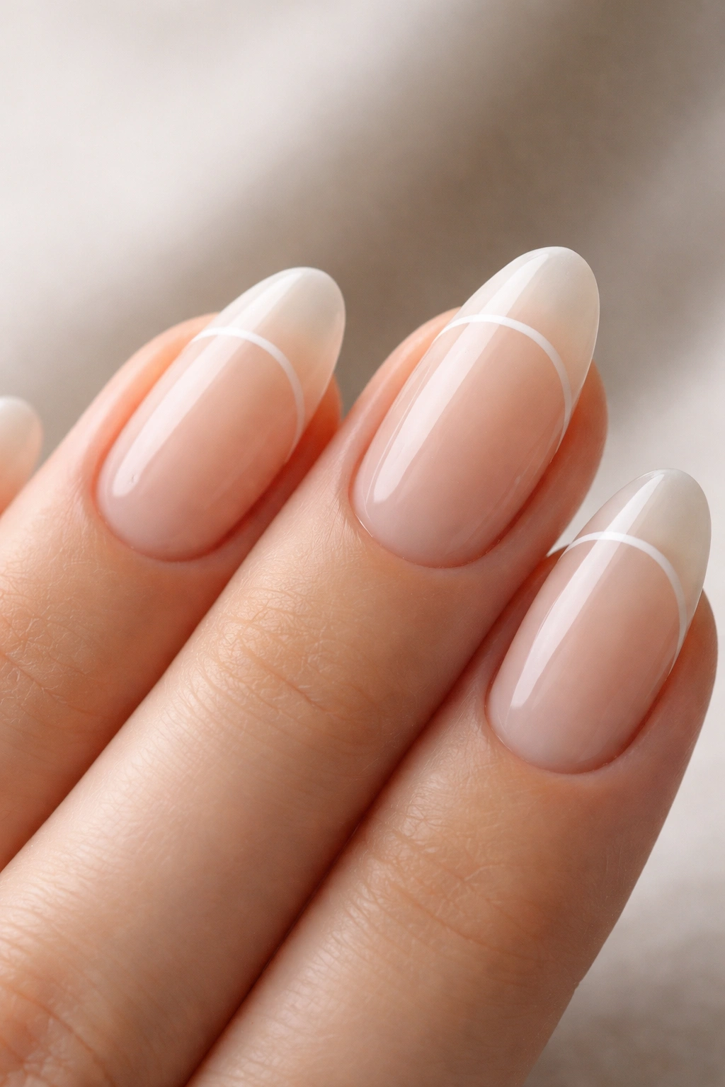 Close-up of a short almond nail with negative space curved line design