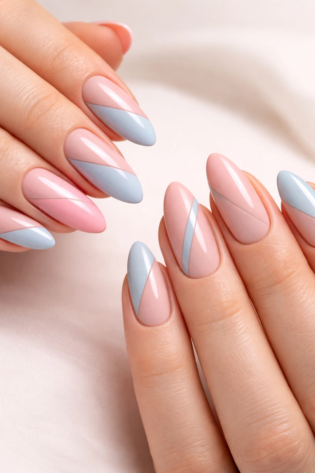 Almond nails with diagonal negative space in pink and blue tones