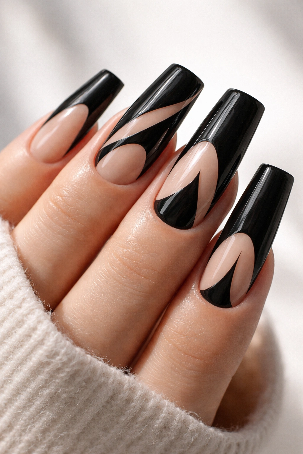 Close-up of black duck nails with geometric negative-space design.