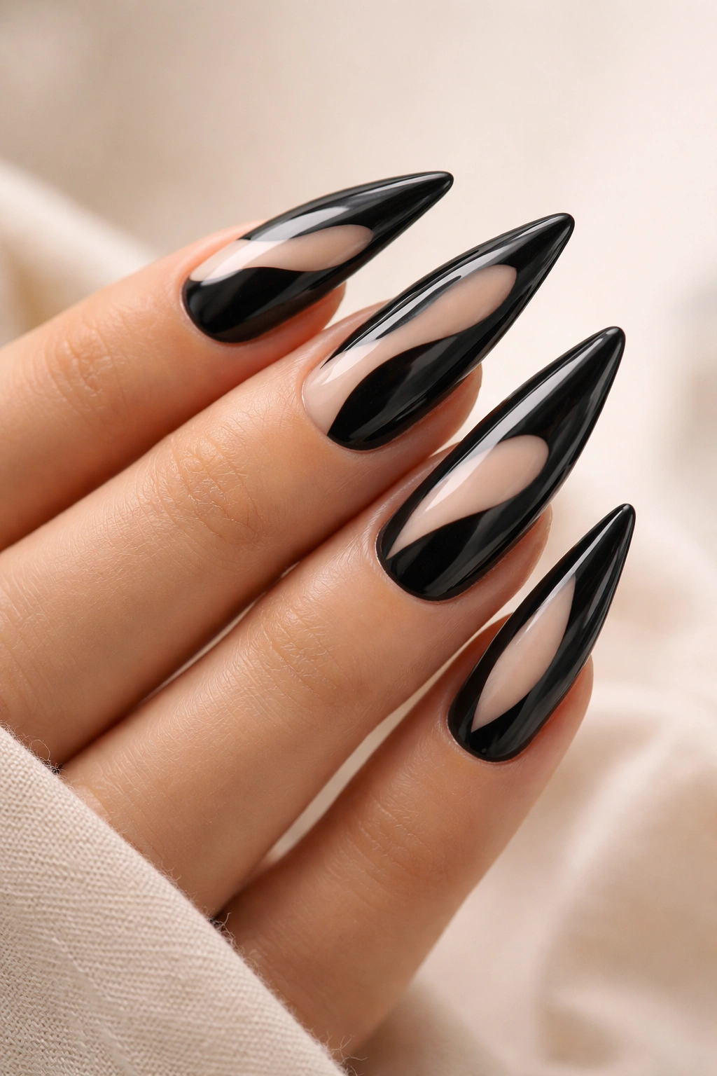 Black stiletto nails with nude negative-space design