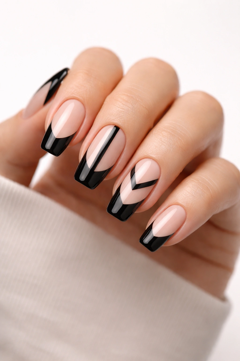 Close-up of nails with black tips and negative space designs