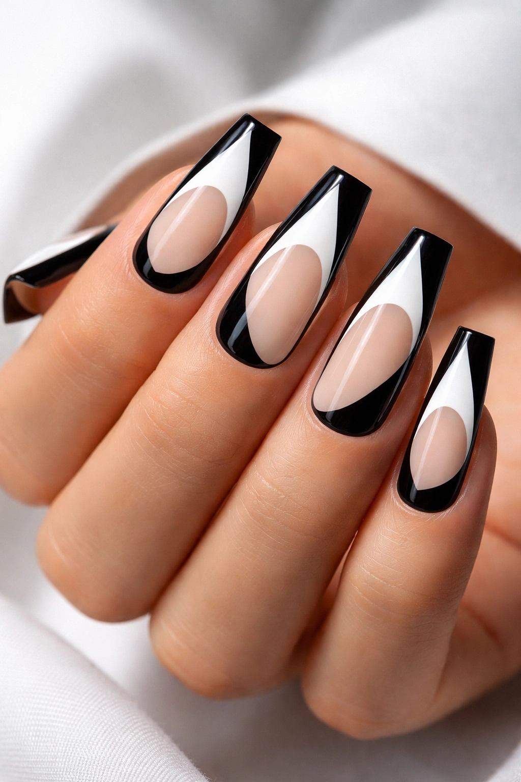 Close-up of coffin nails with negative space black shapes on white base