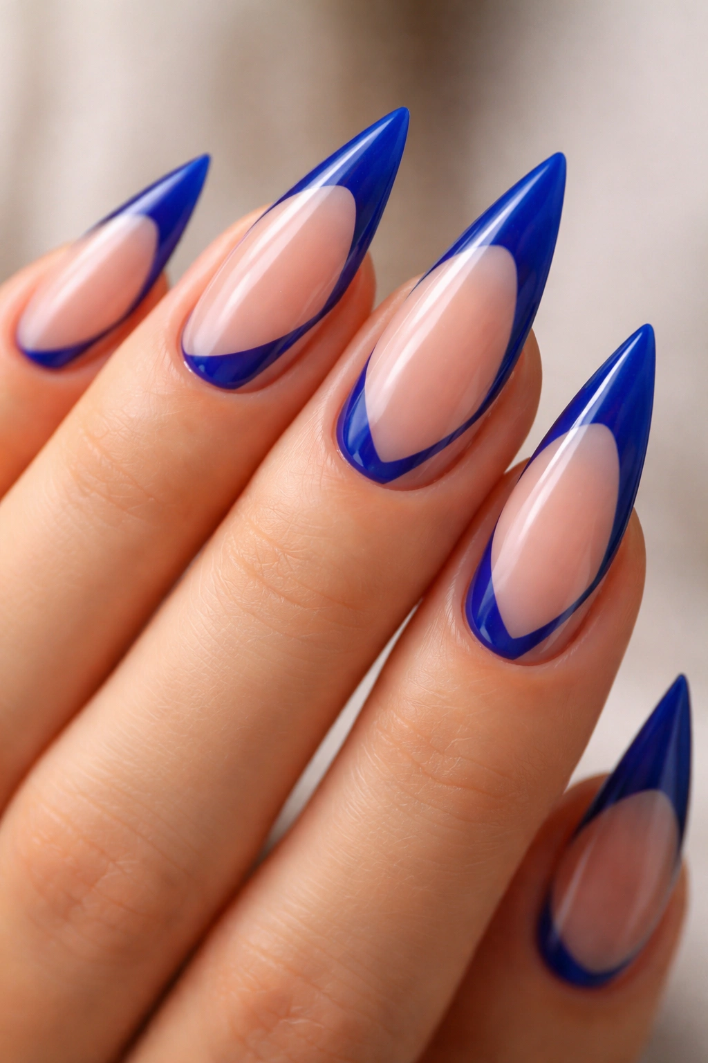 Negative space blue French tip nails on a stiletto nail